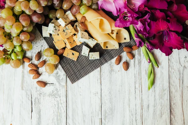 Flowers and food on a white wooden background — Stock Photo, Image