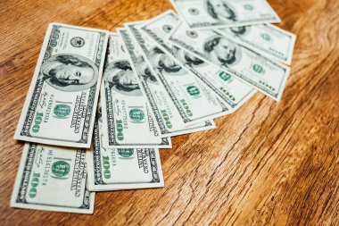 Ahşap arka planda 100 dolarlık banknotlar