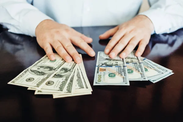 Hundred dollar bills on a wooden background — Stock Photo, Image