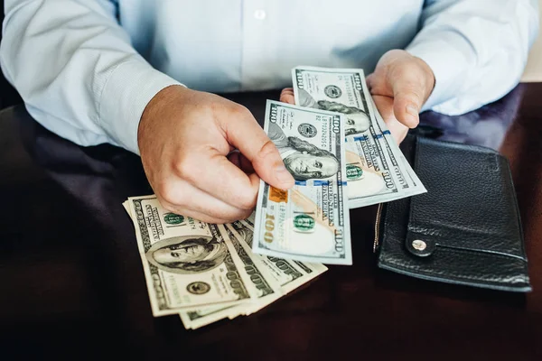 Hundred dollar bills on a wooden background — Stock Photo, Image