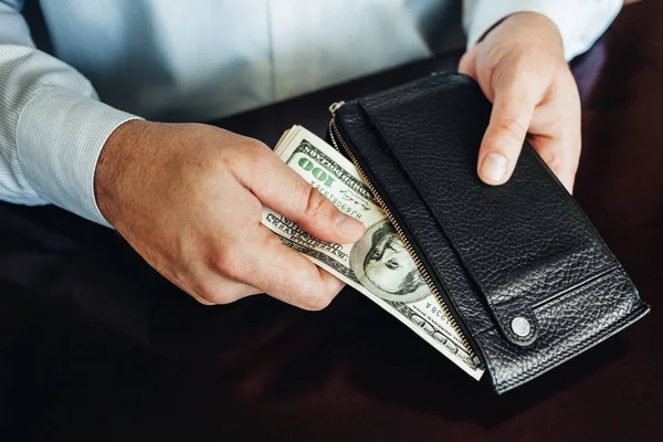 Hundred dollar bills on a wooden background — Stock Photo, Image