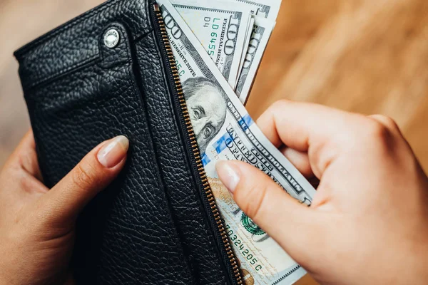 Hundred dollar bills on a wooden background — Stock Photo, Image