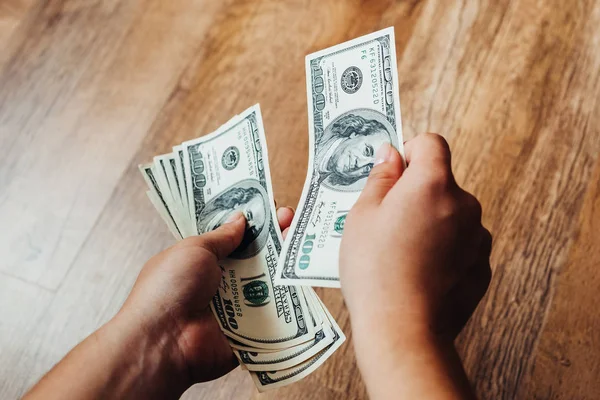 Hundred dollar bills on a wooden background — Stock Photo, Image