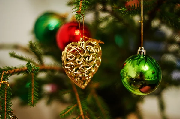 Christmas toy in the shape of a heart on the tree — Stock Photo, Image