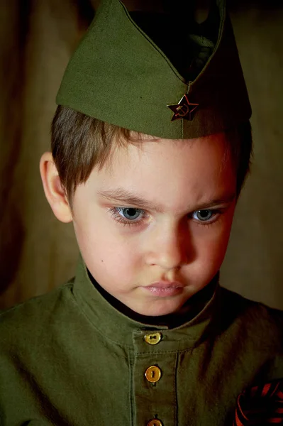 Anos de idade menino na forma militar russa, bonito com olhos azuis . — Fotografia de Stock