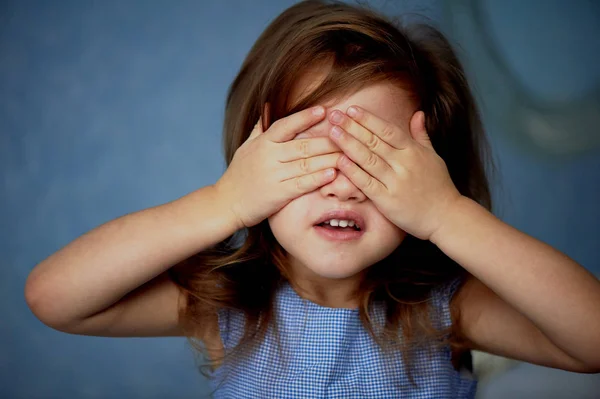 see no evil girl. Baby 3 years covers eyes with hands