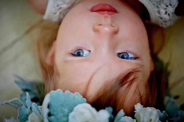 Beautiful little girl in a wreath on the head in green and white. Party dress,  Princess. — Stock Photo, Image