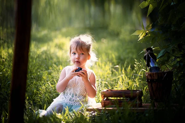 Beautiful little girl at green and white dress, Princess. With pleasure, but on the nature — Stock Photo, Image