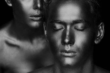 Bir kız ve bir adam altın boya kaplı. Gözlerim kapalı. Kız eğildi, siyah ve beyaz