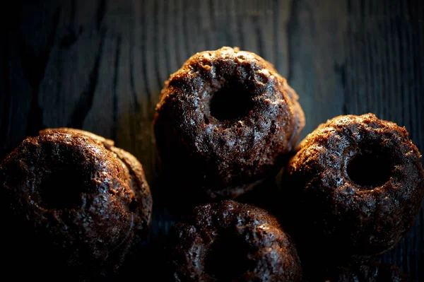 Fresh lush chocolate cupcakes are on the background of dark wood.Studio — Stock Photo, Image