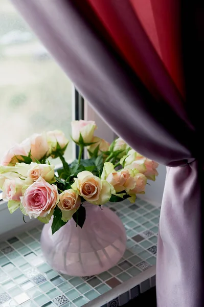 Bouquet of pink roses on the windowsill,in a pink vase. the atmosphere of coziness Royalty Free Stock Photos
