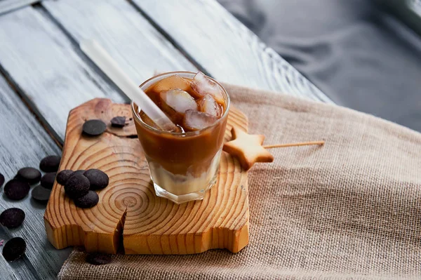 The Hong Kong iced coffee in a glass, with a straw. interesting wooden background — Stock Photo, Image