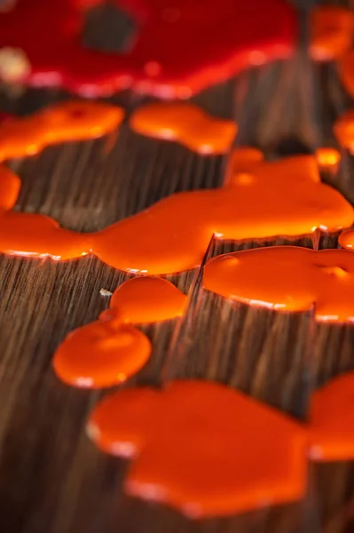 Drops frozen mirror glaze for decorating cakes and pastries.Orange food film — Stock Photo, Image