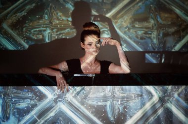 Soyut portre projektör ışığında güzel bir kız. Serin gölgeler. Güzel ve gizemli. Topuz tarzı saç.