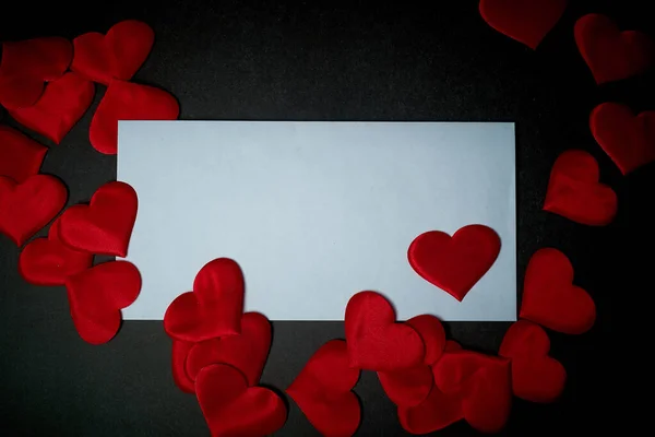 Valentines day,a Declaration of love.White envelope with red hearts. Valentine. On a dark gray background.