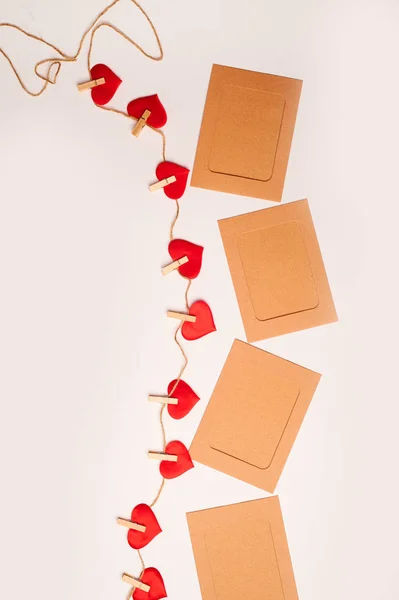 Craft cards, congratulations on valentines day.Hearts on small wooden clothespins on a white background.