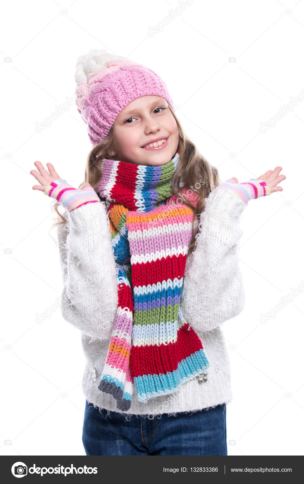 Smiling cute little girl wearing knitted sweater and colorful scarf ...
