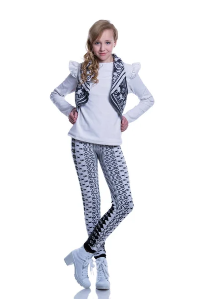 Doce menina adolescente alegre vestindo colete de malha, calças e botas modernas isoladas no fundo branco. Roupas de inverno . — Fotografia de Stock