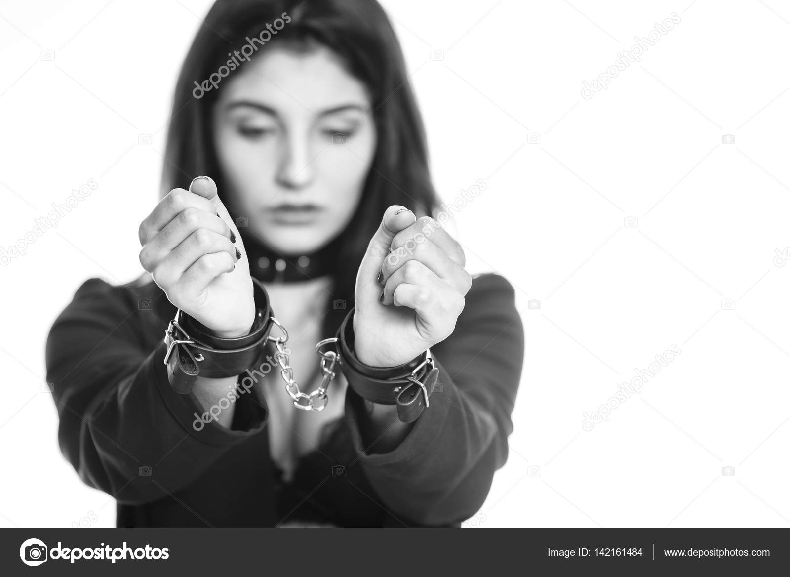 Attractive woman wearing sexy underwear in handcuffs isolated on white ...