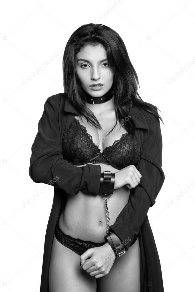 Attractive woman wearing sexy underwear in handcuffs isolated on white background. Violence and discrimination concept.