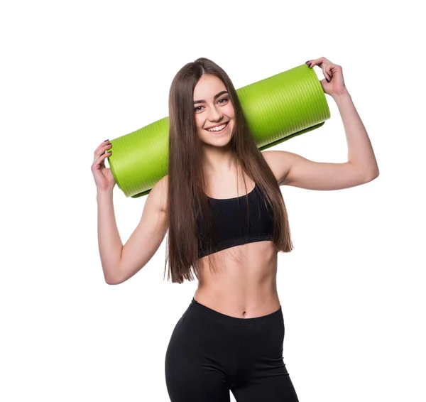 Young attractive fitness woman ready for workout holding green yoga mat isolated on white background. — Stock Photo, Image