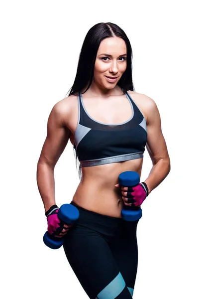 Beautiful young woman do exercises with dumbbells in studio. Sporty athletic girl lifting up weights against white background. — Stock Photo, Image