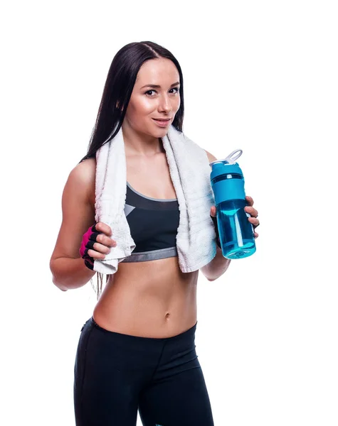 Fitness girl with shaker and towel on a white background. Attractive athletic woman relaxing after workout. — Stock Photo, Image