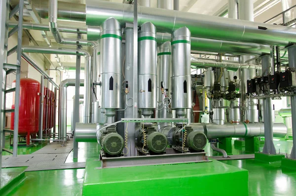 The interior of a modern industrial gas boiler room. Pipelines, water pumps, valves, manometers. — Stock Image The interior of a modern industrial gas boiler room. Pipelines, water pumps, valves, manometers. Royalty Free Stock Images
