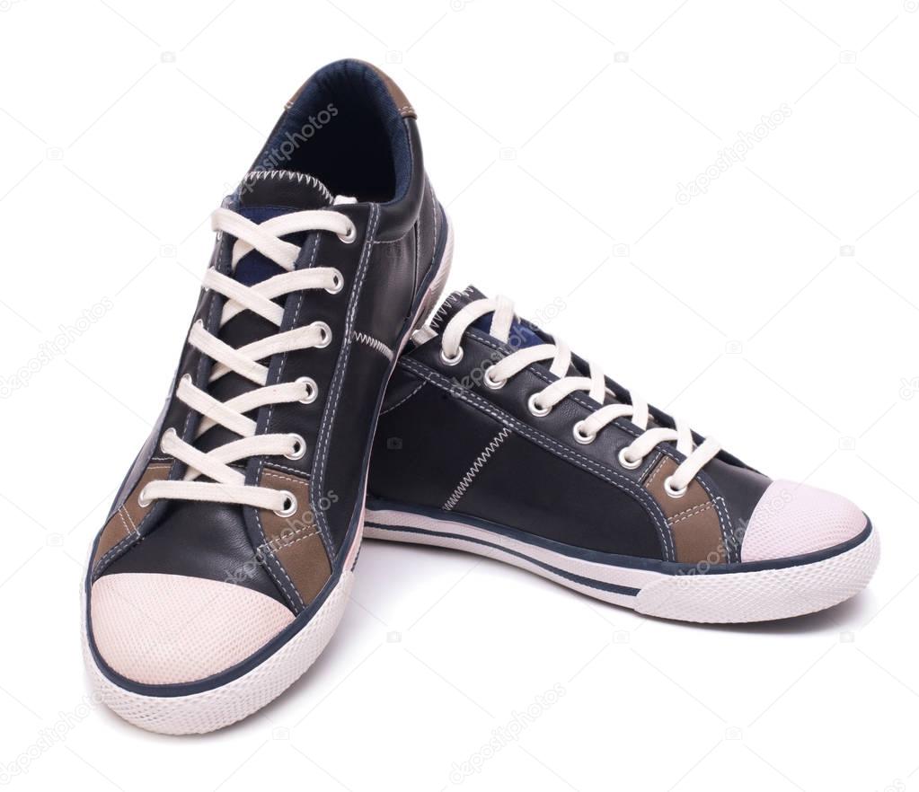 Pair of fashion leather sneakers isolated on white background with clipping path.