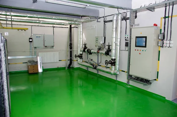 The interior of a modern industrial gas boiler room. Pipelines, water pumps, valves, manometers. — Stock Image The interior of a modern industrial gas boiler room. Pipelines, water pumps, valves, manometers. Royalty Free Stock Images