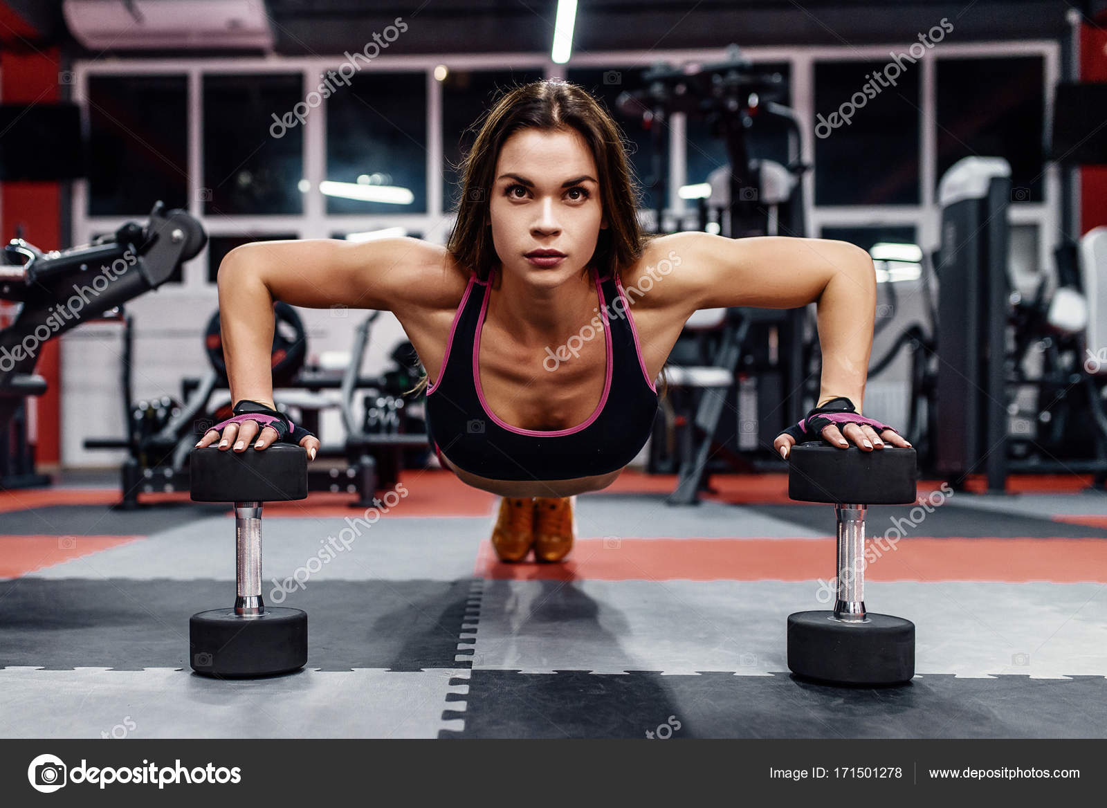 Bikini fitness girl working out with dumbbells. Athlete woman in sportswear  doing exercise in gym. Stock Photo by ©artyme 171501278