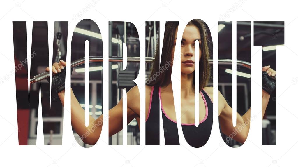 Athlete girl in sportswear working out and training her arms and shoulders with exercise machine in gym. Motivation sign.