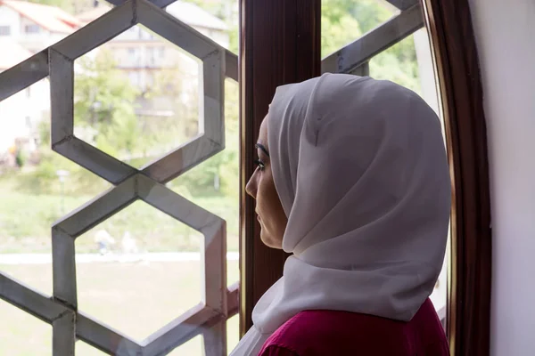 Girl with hijab reading koran and praying