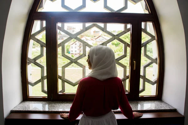 Girl with hijab reading koran and praying