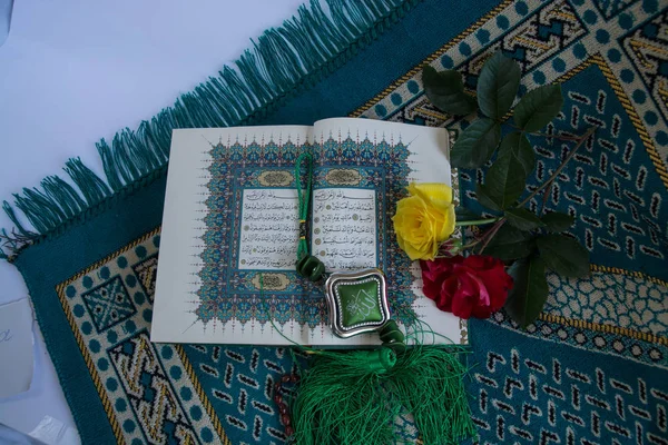Corán con rosario y flores aisladas sobre fondo blanco — Foto de Stock