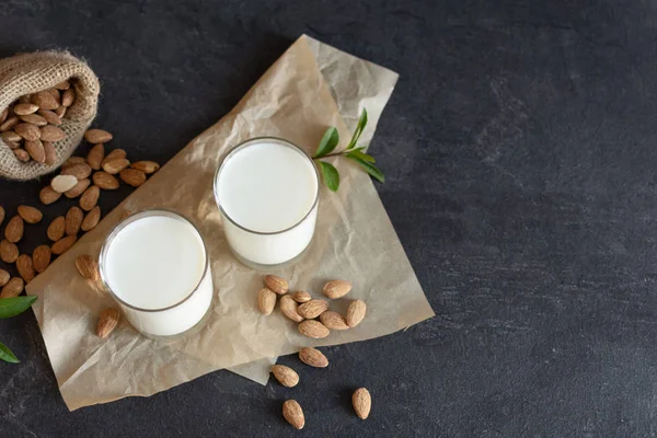 Organic Almond milk in glass with almond nuts. Healthy eating concept.