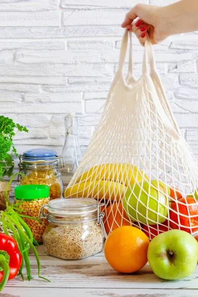 Cotton mesh bag for grocery with fruits and vegetables. Zero waste, no plastic shopping. Sustainable lifestyle concept. — 스톡 사진