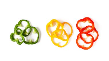 Set of colorful sliced bell pepper isolated on white background top view.
