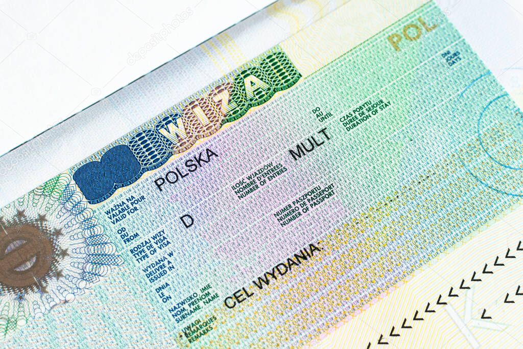 Fragment of Schengen multi entrance Polish visa in passport close-up.