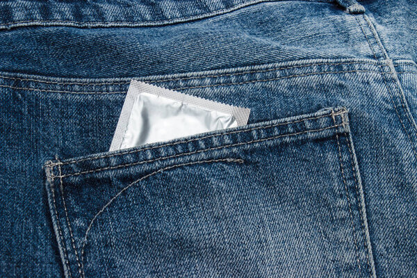 Condoms in package in jeans.