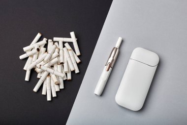Elektronik Sigara Teknolojisi. Tütün IQOS sistemi. Elektrikli hibrit sigarayı ısıtma yastığıyla kapatın. tütün ısıtma sistemi. Yeni tütün ısıtma sistemi. Elektronik sigara mokaseni.