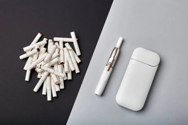 Elektronik Sigara Teknolojisi. Tütün IQOS sistemi. Elektrikli hibrit sigarayı ısıtma yastığıyla kapatın. tütün ısıtma sistemi. Yeni tütün ısıtma sistemi. Elektronik sigara mokaseni.
