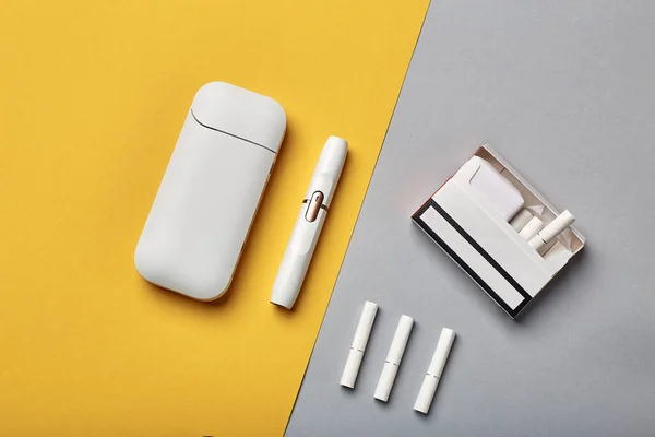 Elektronik Sigara Teknolojisi. Tütün IQOS sistemi. Elektrikli hibrit sigarayı ısıtma yastığıyla kapatın. tütün ısıtma sistemi. Yeni tütün ısıtma sistemi. Elektronik sigara mokaseni.
