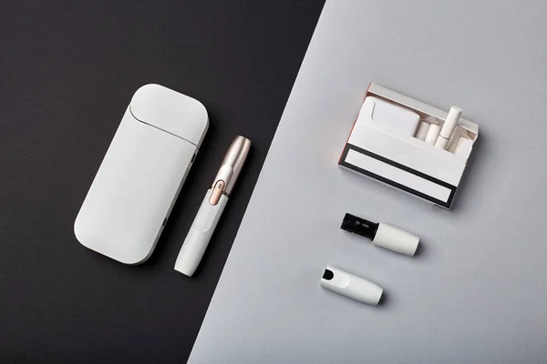 Elektronik Sigara Teknolojisi. Tütün IQOS sistemi. Elektrikli hibrit sigarayı ısıtma yastığıyla kapatın. tütün ısıtma sistemi. Yeni tütün ısıtma sistemi. Elektronik sigara mokaseni.