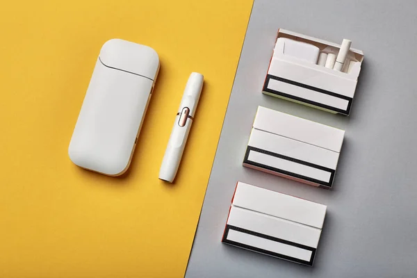 Elektronik Sigara Teknolojisi. Tütün IQOS sistemi. Elektrikli hibrit sigarayı ısıtma yastığıyla kapatın. tütün ısıtma sistemi. Yeni tütün ısıtma sistemi. Elektronik sigara mokaseni.