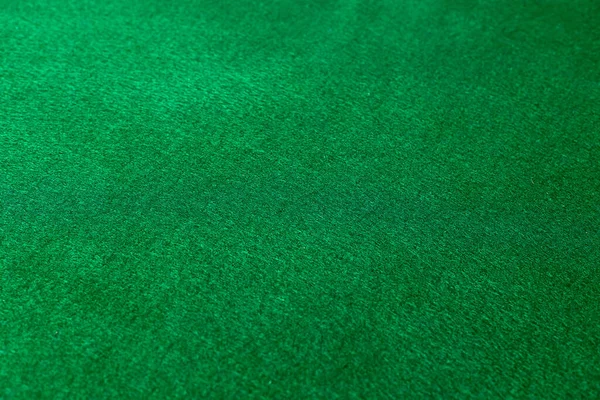 Green poker table background. casino concept. Close-up.