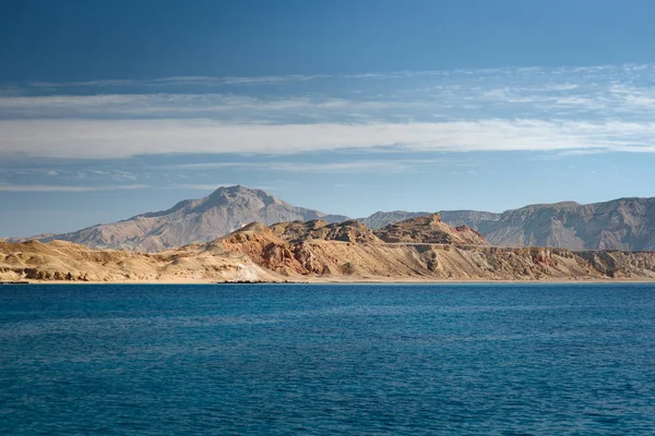 View at the desert island Tiran in Red sea. Landscape with an uninhabited island in sea with clear turquoise water. Vacation in an exotic country.