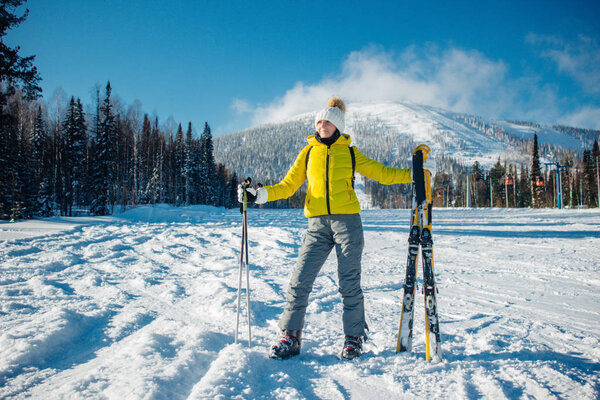 Beautiful young sport woman in yellow grey winter clothes stands