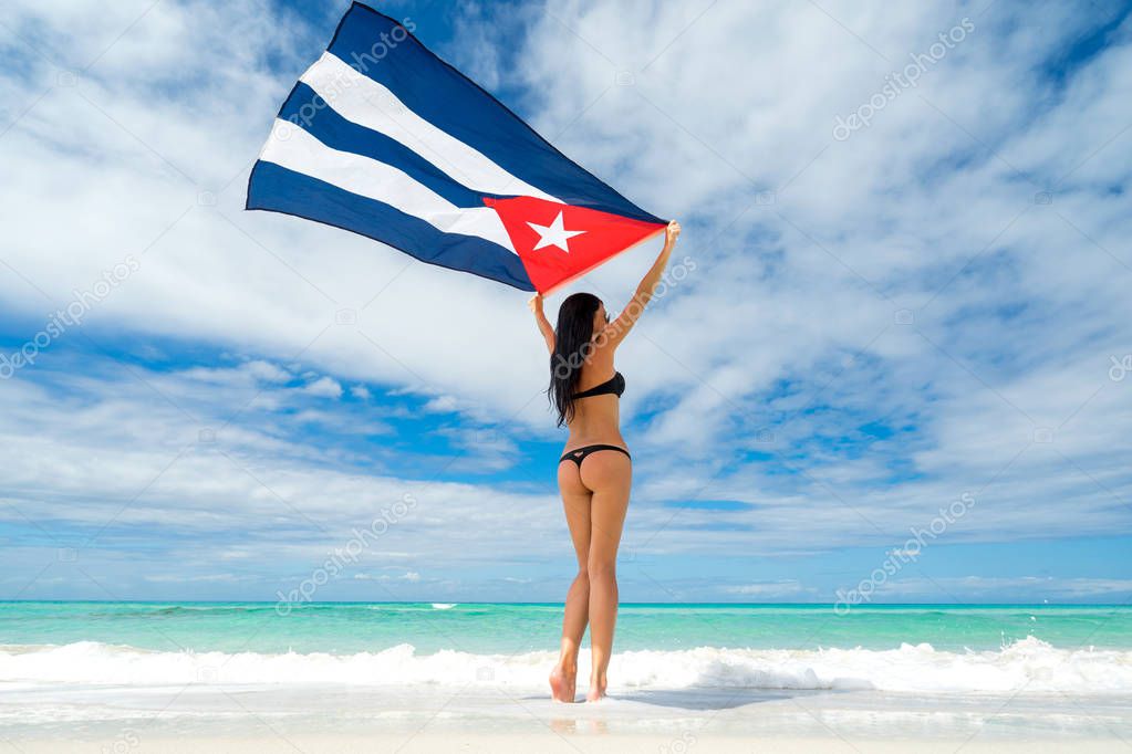 Beautiful young woman in black bikini swimsuit hold a flag of Cua