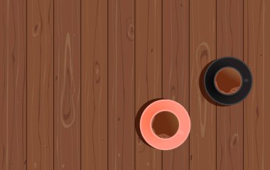 Ahşap masada pembe ve siyah bir fincan kahve. İki porsiyon sade kahve. Yukarıdan görüntüle